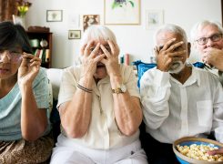 senior-friends-sitting-on-the-couch-with-8etny7d-245×180